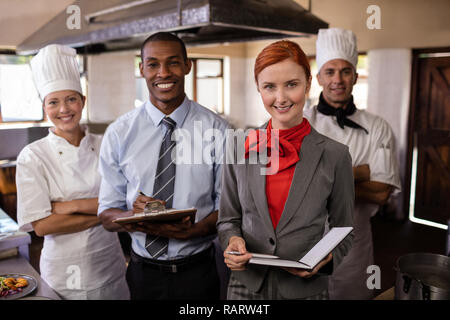 Group of hotel staffs standing in kitchen Stock Photo