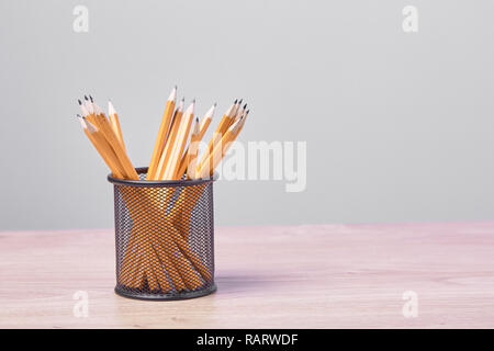 Graphite pencils in a metal grid-container. Concept. Stock Photo