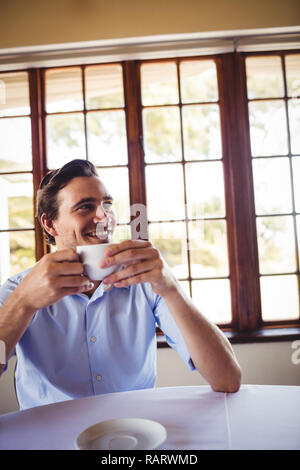 Man having coffee in restaurant Stock Photo
