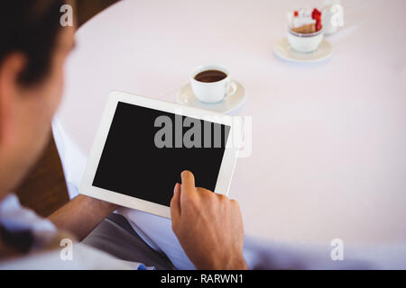 Man using digital tablet in restaurant Stock Photo