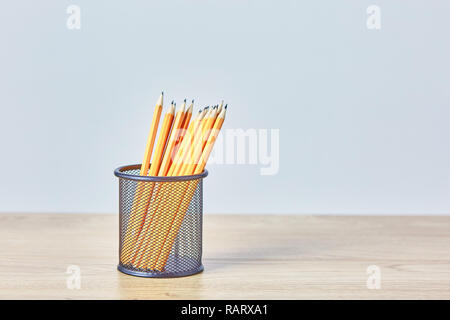 Graphite pencils in a metal grid-container. Concept. Stock Photo