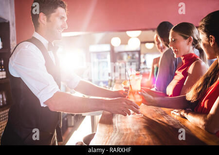 Bartender serving drinks to customer Stock Photo