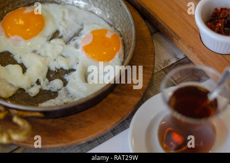 Fried eggs and turkish tea on the table,top view. Stock Photo