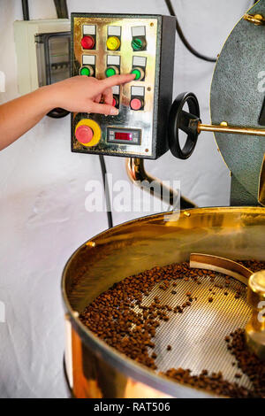 Female Handles Roaster in Organic Coffee production Stock Photo