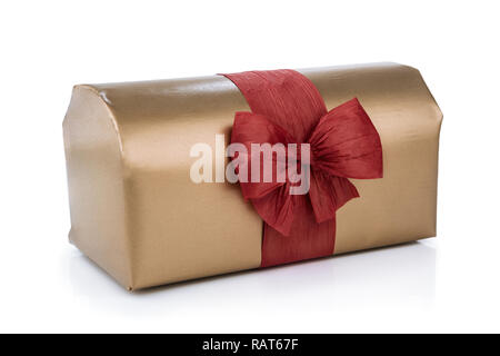 Gift box wrapped in gold wrapping paper, decorated with red raffia ribbon and bow isolated on the white background Stock Photo