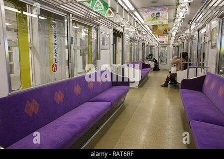 KYOTO, JAPAN - APRIL 15, 2012: Passengers ride Kyoto Municipal Subway train in Japan. Kyoto Subway operates since 1981 and has 31 stations. Stock Photo