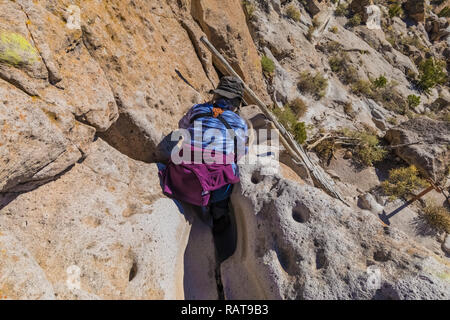Karen Rentz hiking trail cut into soft volcanic tuff rock by footwear through the years, at the Tsankawi Prehistoric Sites in Bandelier National Monum Stock Photo
