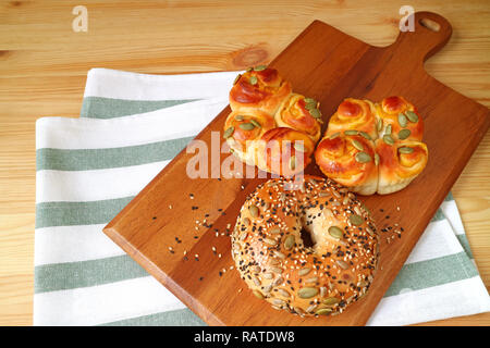 Breads with Pumpkin Seeds, Sunflower Seeds and Sesame in Different Types on Wooden Tray Served on the Table Stock Photo