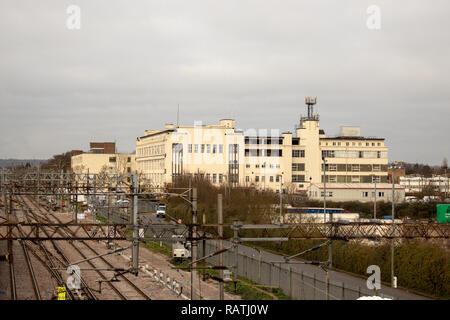 Large factory style building next to railway lines in North London Stock Photo