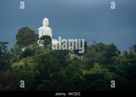 The 26.83 m (88.0 ft) tall sitting Buddha statue at the Sri Maha Bodhi Viharaya temple, in Kandy, Sri Lanka. Stock Photo