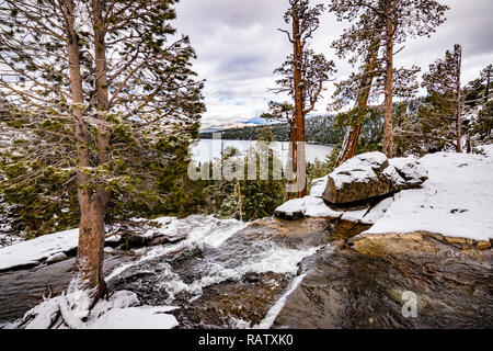 Lower Eagle falls on a cloudy winter day, Emerald bay and Lake Tahoe visible in the background Stock Photo