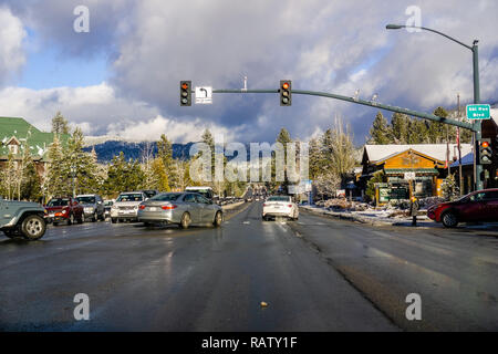 December 25, 2018 South Lake Tahoe / CA / USA - Driving through South Lake Tahoe on a sunny day; storm clouds gathering the the background Stock Photo