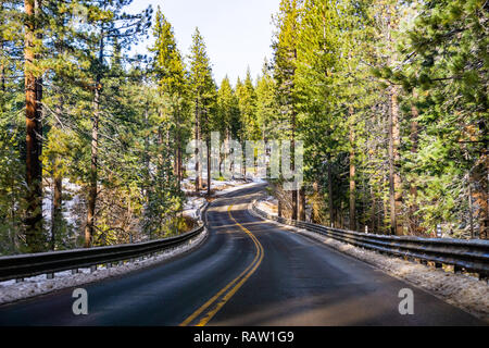 Travelling on a winding road on the shoreline of Lake Tahoe on a winter day Stock Photo