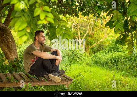 Caucasian man enjoying nature alone, having a break from technology. Stock Photo