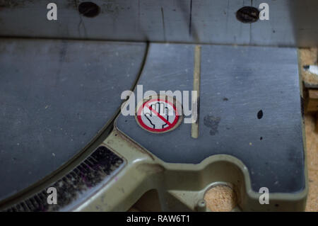 Carpenter using a Makita compound miter saw at carpentry workshop Stock Photo