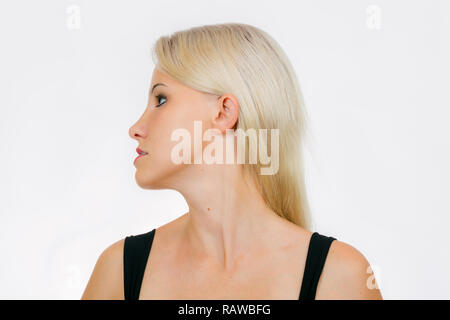 Face exercise, woman turn head to left and  shift bottom jaw close-up Stock Photo