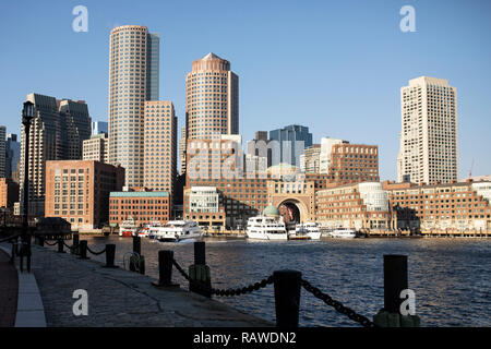 A view across Boston Harbor from Fan Pier Park and the Harborwalk to Rowes Wharf and the skyline of the financial district, in Massachusetts, USA. Stock Photo