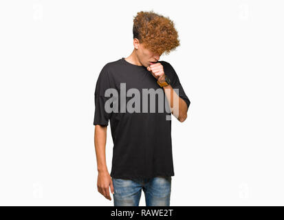 Young handsome man with afro hair wearing black t-shirt feeling unwell and coughing as symptom for cold or bronchitis. Healthcare concept. Stock Photo