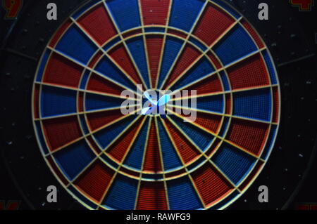 Game of darts, person playing darts hitting bulls eye Stock Photo