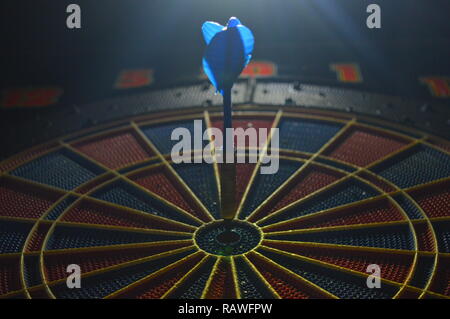 Game of darts, person playing darts hitting bulls eye Stock Photo