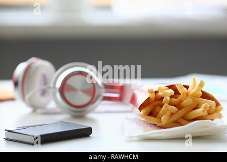 French fries with headphones lying on Stock Photo