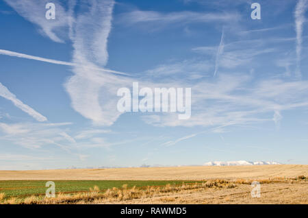 What is going on?  How many airplanes are in the sky? See the fog on the ground and in the mountains. Stock Photo