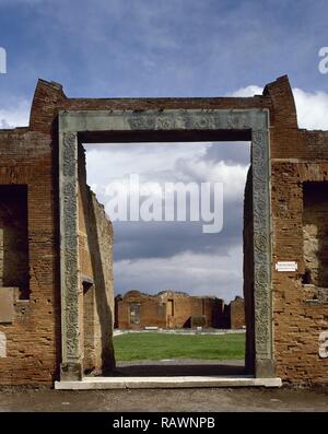 Italy. Pompeii. Building of Eumachia (VII,9,1). It was erected in the Tiberian period (14-37 AD), next to the public forum. View of the portal decorated with garlands of acanthus leaves and animals, built after 62 AD. Campania. Stock Photo