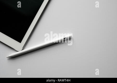 Tablet / Pad with White / Silver Digital Pencil / Pen / Stylus Design Workspace Studio White Background Creative Technology Stock Photo