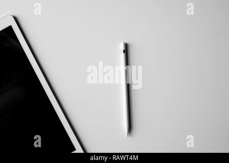 Tablet / Pad with White / Silver Digital Pencil / Pen / Stylus Design Workspace Studio White Background Creative Technology Stock Photo
