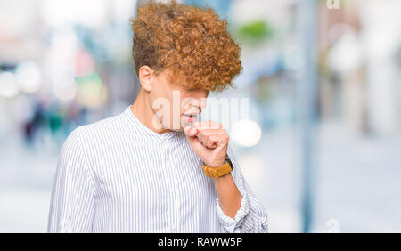 Young handsome business man with afro hair wearing elegant shirt feeling unwell and coughing as symptom for cold or bronchitis. Healthcare concept. Stock Photo