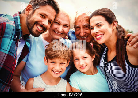 Happy multi generation family standing against sky Stock Photo