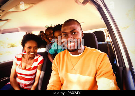 Happy family sitting in car Stock Photo