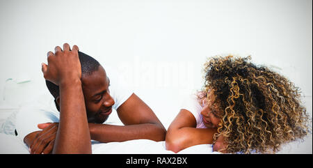 Young couple lying on bed and talking Stock Photo