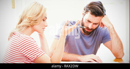 Worried young couple checking on bills Stock Photo