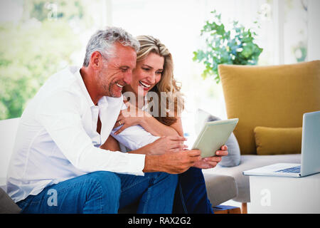 Smart mature couple using digital tablet Stock Photo