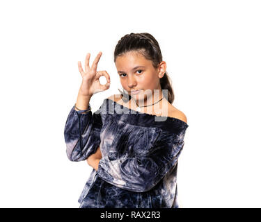 Young primary school aged school girl pointing ok or okay hand sign. Stock Photo