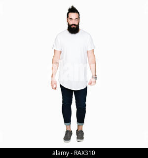 Young hipster man with long hair and beard wearing casual white t-shirt skeptic and nervous, frowning upset because of problem. Negative person. Stock Photo