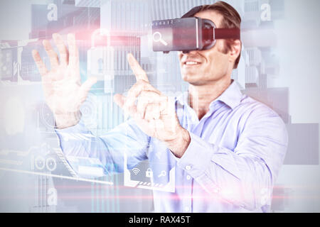 Composite image of businessman wearing vr glasses Stock Photo