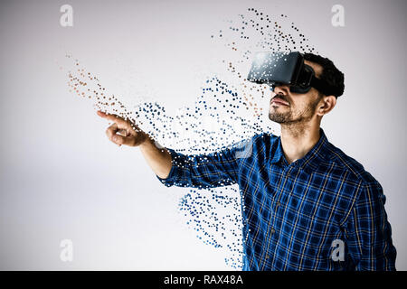 Composite image of businessman looking though virtual reality simulator against white background Stock Photo