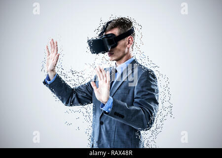 Composite image of businessman using virtual reality headset Stock Photo
