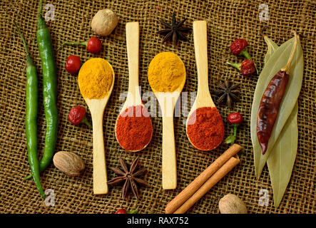 Powdered spices and whole spices on hessian cloth. Stock Photo