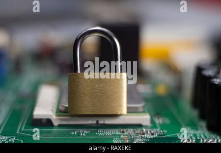 Closed lock on a computer mainboard chip. Digital security, locking processor concept Stock Photo