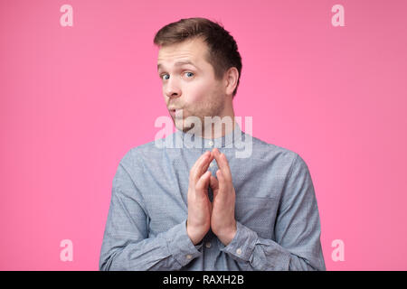 Cunning tricky mature man thinking looking with hand together over pink background. Concept of unfair game Stock Photo
