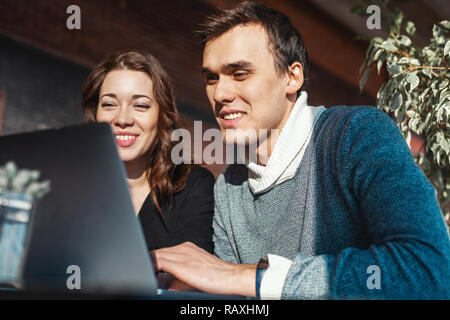 Young man and woman working in front of the laptop. Team meeting,work process. Stock Photo