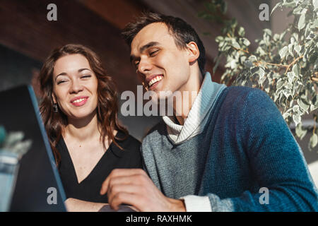 Young man and woman working in front of the laptop. Team meeting,work process. Stock Photo