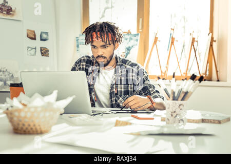 Modern freelancer feeling overloaded having too much work Stock Photo