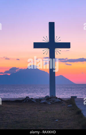 Silhouette of cross and mount Athos at sunrise or sunset and sea panorama in Greece Stock Photo