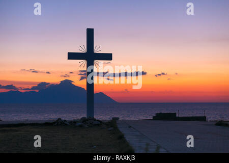 Silhouette of cross and mount Athos at sunrise or sunset and sea panorama in Greece Stock Photo