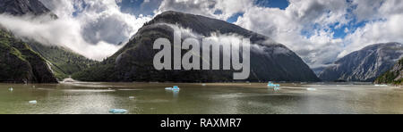Beautiful panoramic view of mountains covered with clouds in Alaskan fjord Stock Photo