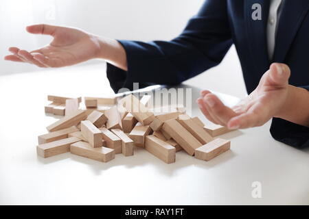 Planning risk and strategy in businessman gambling failure of wooden blocks stag. Business concept for growth and success process. Stock Photo